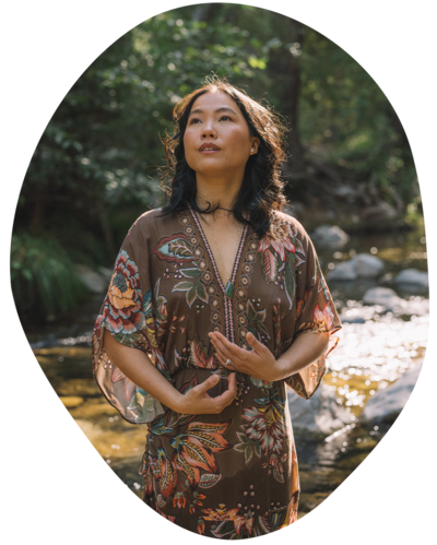 Joanne Lai standing in river thinking about somatic and holistic therapy