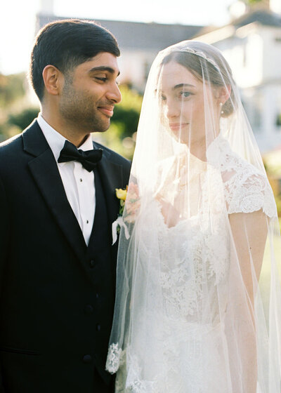 groom glancing at his bride lovingly