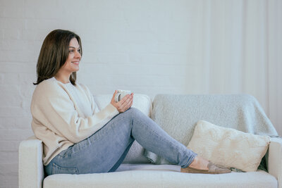 Brand photography of a lady sat on a sofa