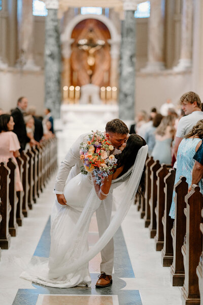 a bride and groom in a Catholic Church