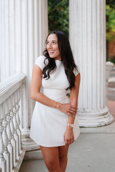 Graduate in white dress poses at the University of Tennessee, Knoxville