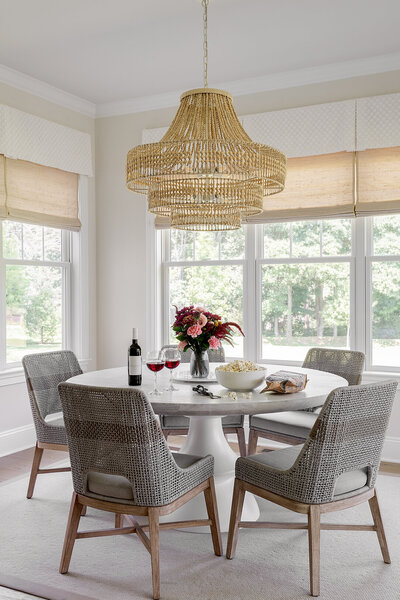 round table with four chairs in front of windows