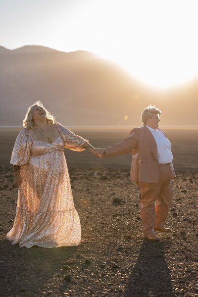 A newlywed couple kissing in the desert