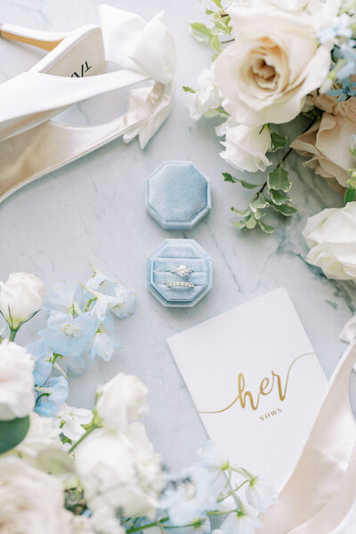 Elegant wedding details with blue ring box and vow book styled by Toronto wedding photographer