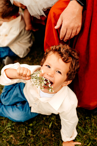 Little boy pretends to eat flower during family photoshoot powell ohio
