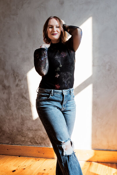 woman stands in front of wall