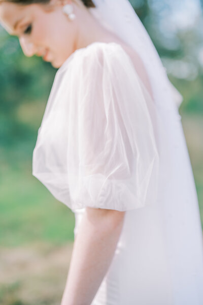 Close up of the sheer sleeve of a bride's wedding dress