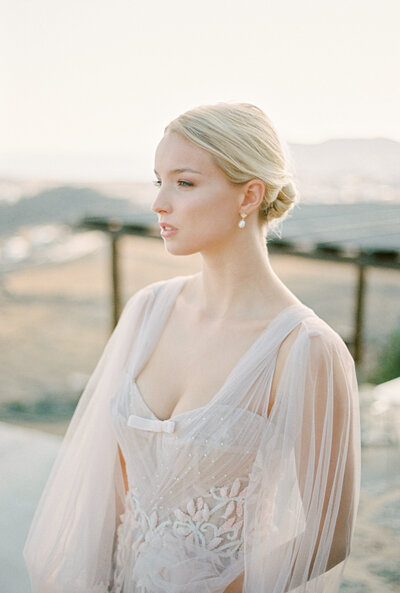 Bride back dress detail with a piece of jewelry during a weddding at chateau pape clement