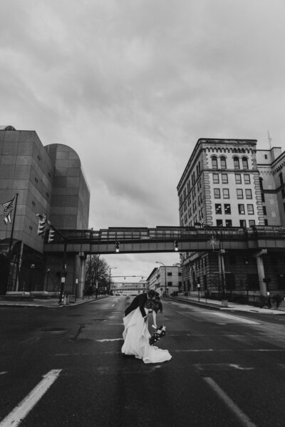 Wedding Couple kiss in downtown Akron in the street.
