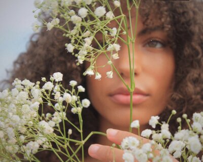 Image of woman modeling with flower from Film engagement photographer at ADP Studio