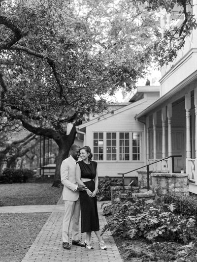 Black and white photo of bride and groom outside of rehearsal dinner venue