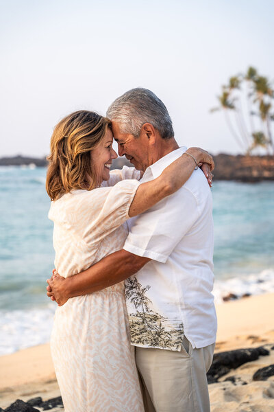 Couple smiling for beach photos with Big Island Hawaii photographer at Hawaii Adventure Portraits