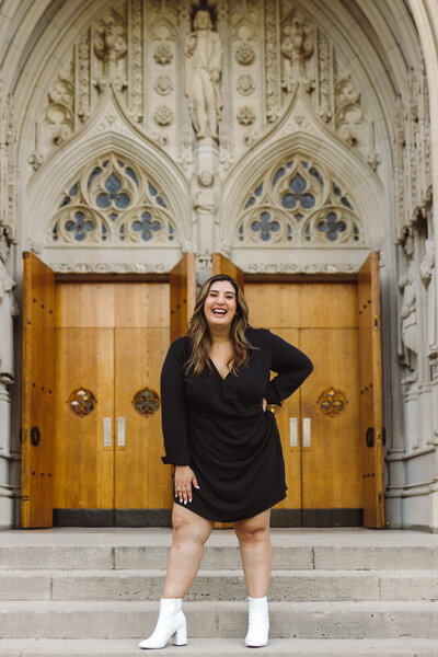 Duke University graduate smiling on the steps of the Chapel.