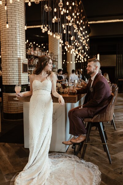 bride and groom sitting at the bar enjoying a cocktail