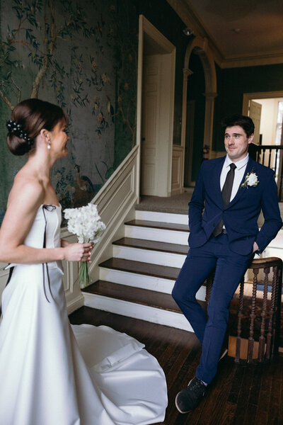 Vermont Wedding Photographers | Sincerely Liz Photography Documentary Wedding, Engagement, Elopement, Maternity and Newborn Photographer in New England | Groom admiring bride as she walks up the stairs at a New England mansion wedding