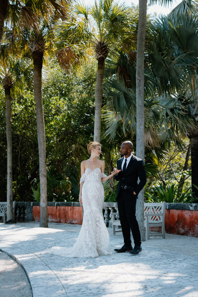 Elegant editorial biracial wedding portrait at Vizcaya Gardens in Miami, Florida