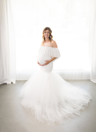 A beautiful pregnant mother in a flowy maternity gown.
