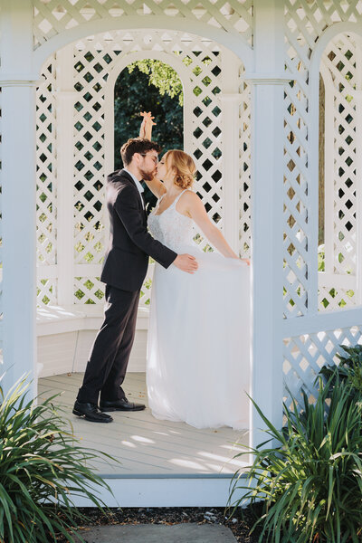 young, newly married couple  dancing in a white gazebo. Photo taken by Philly Wedding Photographer Eric Boylan Photography