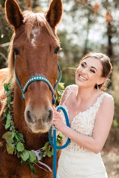 Bride smiling at her horse during photoshoot at Grace Valley Farm