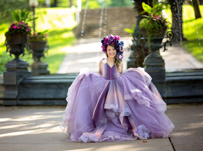 Girl in front of fountain with big purple ombre gown on