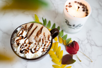 a mocha in a mug topped with whipped cream and chocolate drizzle