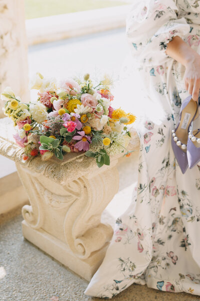 bride looks off in distance smiling while groom kisses her cheek philadelphia wedding photographer emily wilkerson