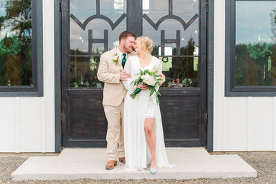 Bride and groom sharing a moment after their wedding ceremony at barn at mader farm in genesee idaho where they are walking away and holding hands