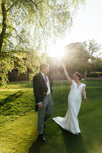 Bride and goom posing for portrait in front of church door