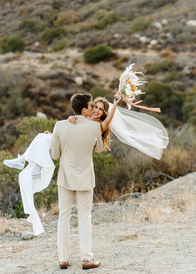 Couple dancing and  laughing in their engagement photo at Shaws Cove in Laguna Beach