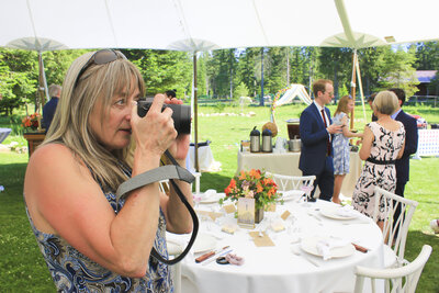 Photographer  taking picture in a garden of wedding guests