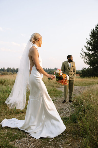 bride and groom holding hands while their bridal party is standing around them