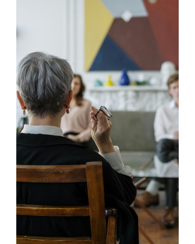 Back of a Woman's head holding glasses