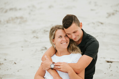 A romantic moment captured on Vermont's serene beaches, as a couple enjoys the sand, sea, and each other's company.