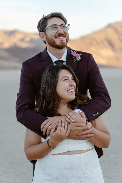 A person on their partner's back as they both smile