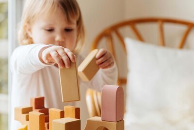 Young girl playing with wooden blocks