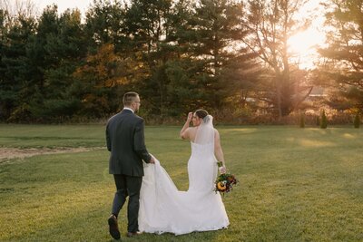 A just married couple pours a champagne tower together after their Toledo, Ohio wedding