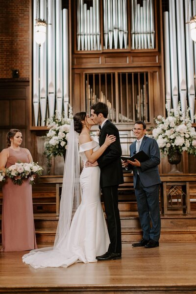 Bride and Groom in Classic timeless attire kissing after ceremony at Scarritt Bennett Center