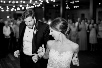 Black and white photo of bride and groom dancing