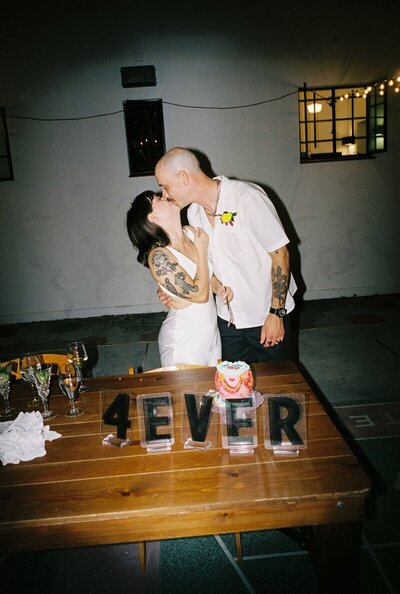 film image of bride and groom kissing by best candid wedding photographers Noble Photo Co