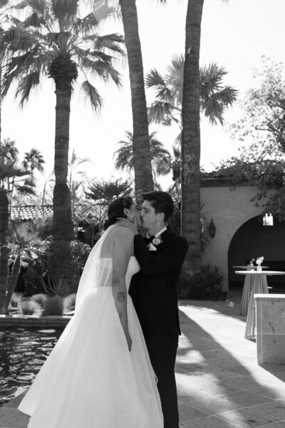 Bride and groom embrace in an elegant moment at a luxurious Arizona wedding venue.