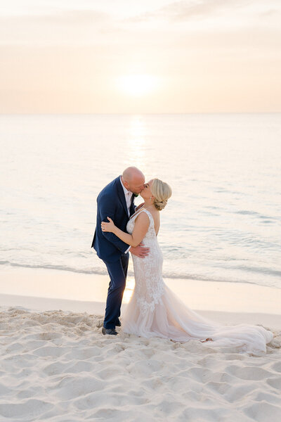 Bride and groom kissing on Aruba's beach