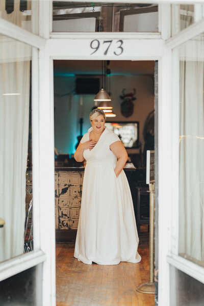 An embroidered dot lace a-line wedding gown with pockets.