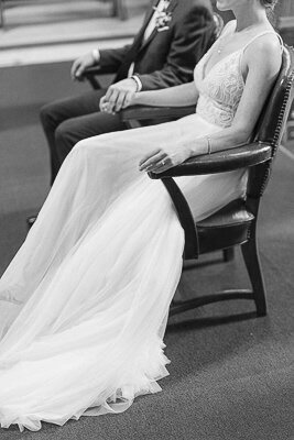 The bride and groom hold hands at the wedding ceremony.