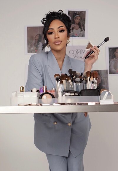 Luxury bridal makeup artist in NYC dressed elegantly with professional skincare and makeup tools, offering skin-prep-focused bridal services.