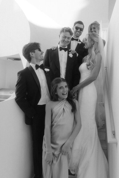 Wedding party posing on stairs of private home