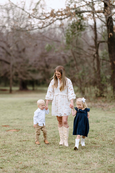 spring family photo of Longview, TX family wearing neutral colors standing in open field