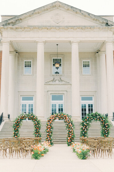 three flower arches in front of venue