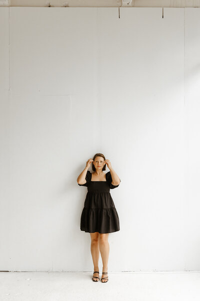 photographer holding up hands smiling
