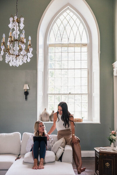 kat smiling with black jacket on shoulders