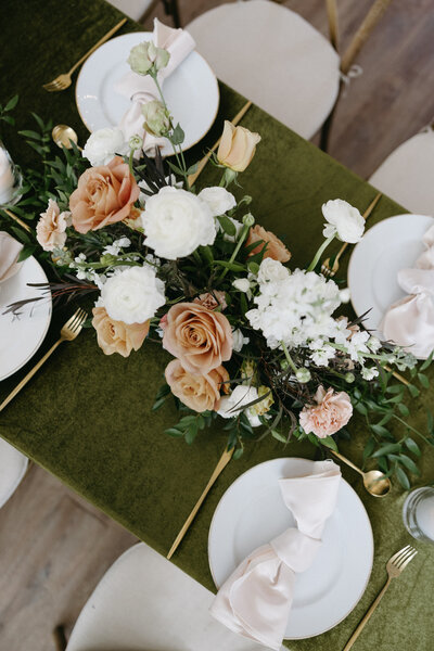 wedding styled table with green tablecloth
